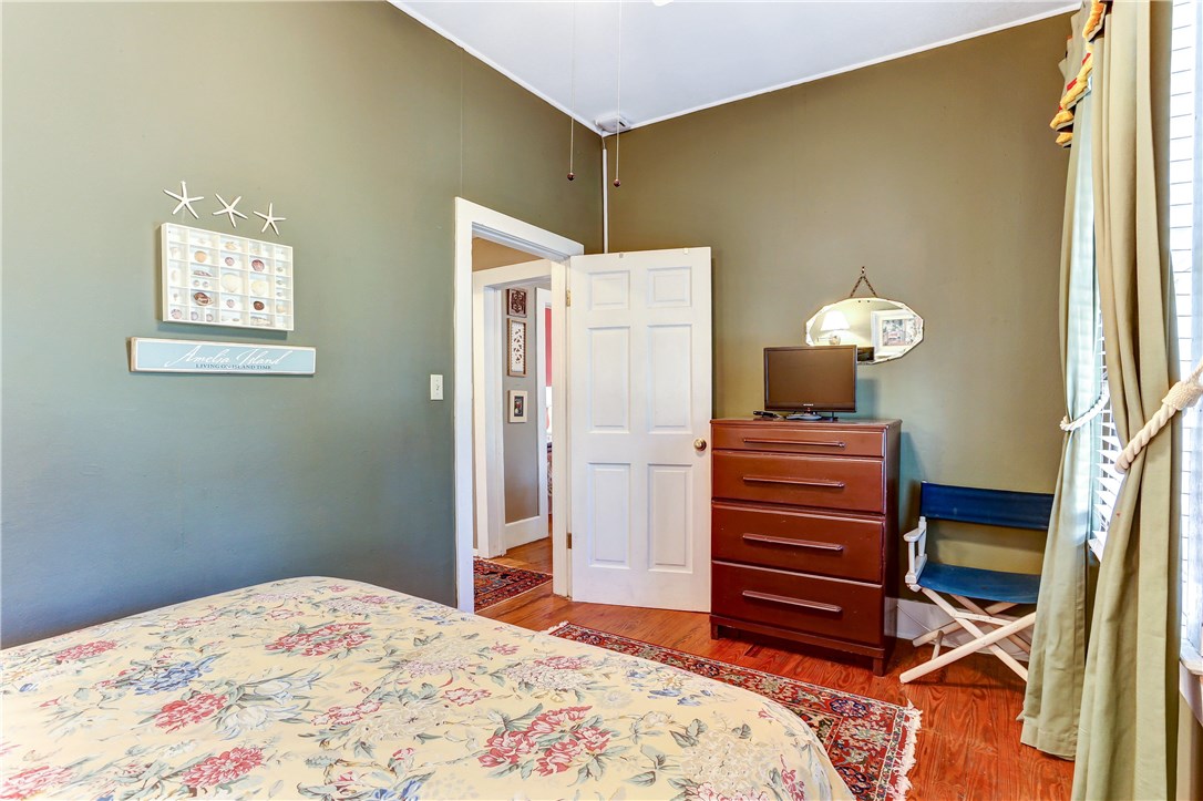 603 Broome Street Fernandina Beach, FL 32034 - Photo 22 of 33 a bedroom with a bed and a dresser in it