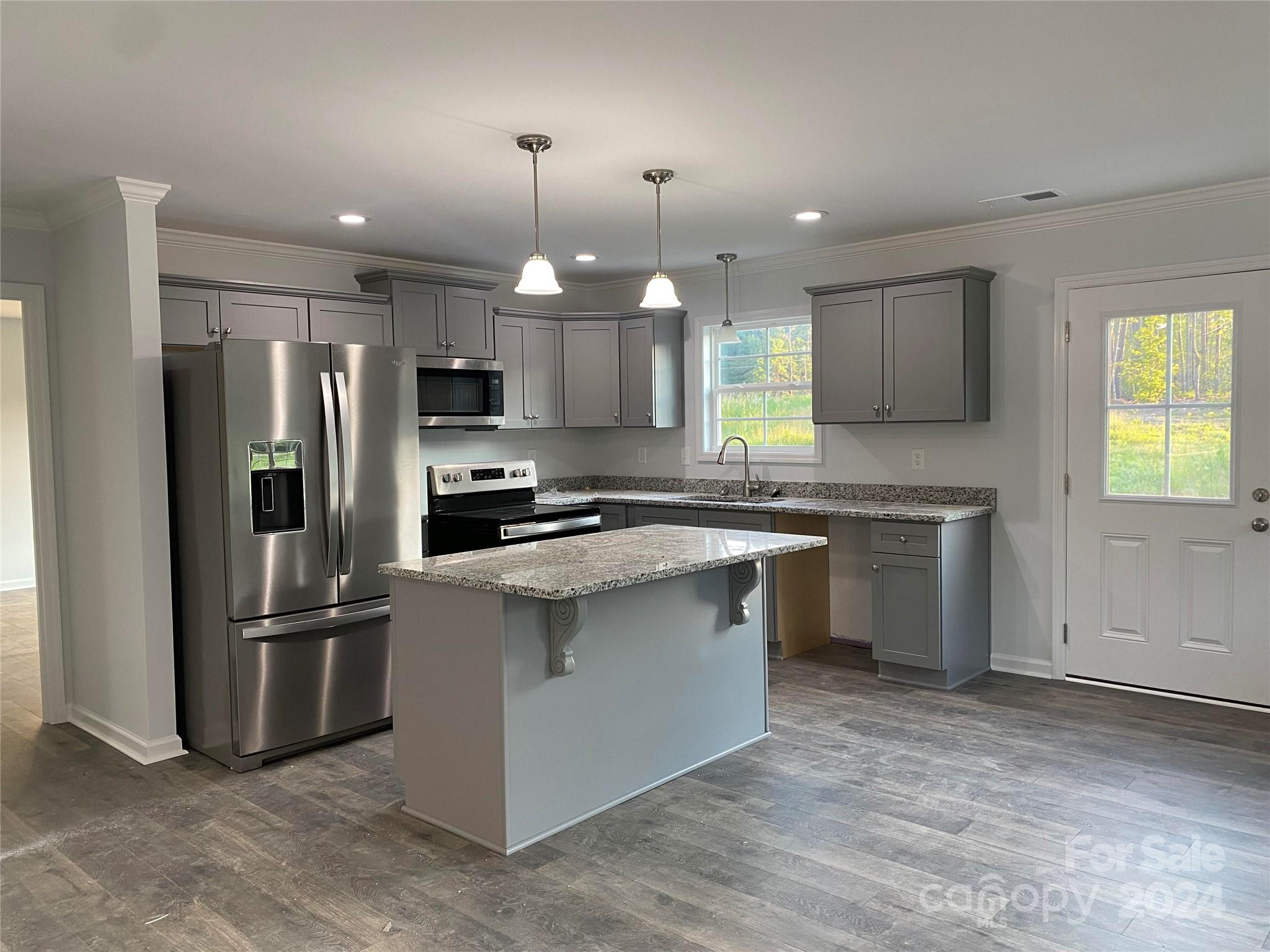 782 Starcliff Circle Lancaster, SC 29720 - Photo 5 of 8 a kitchen with stainless steel appliances granite countertop a refrigerator a sink a stove a microwave and island