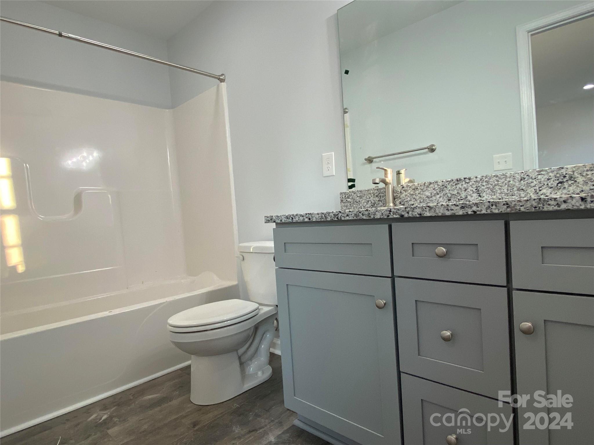 782 Starcliff Circle Lancaster, SC 29720 - Photo 8 of 8 a bathroom with a granite countertop toilet a sink and a mirror