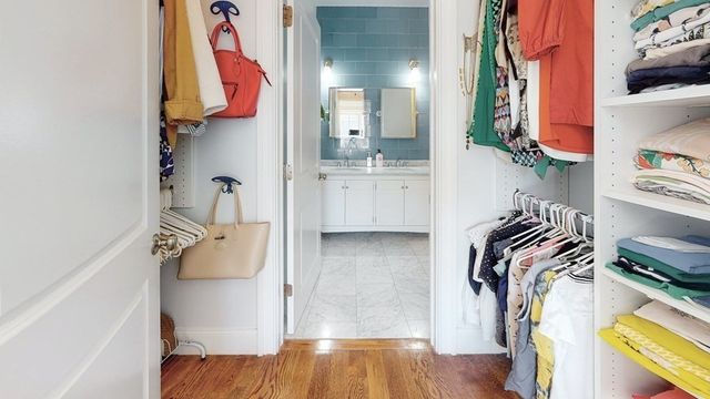 a view of walk in closet with clothes and shoes