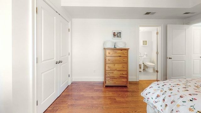 a view of bedroom with wooden floor