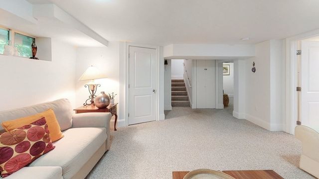 a living room with furniture and a walk in closet