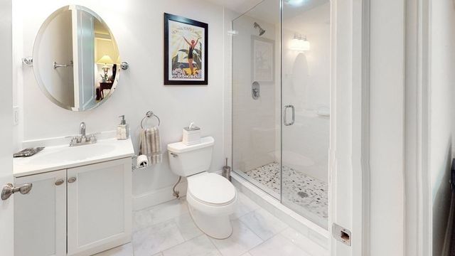 a bathroom with a toilet sink and shower