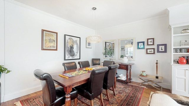 a view of a dining room with furniture and a potted plant