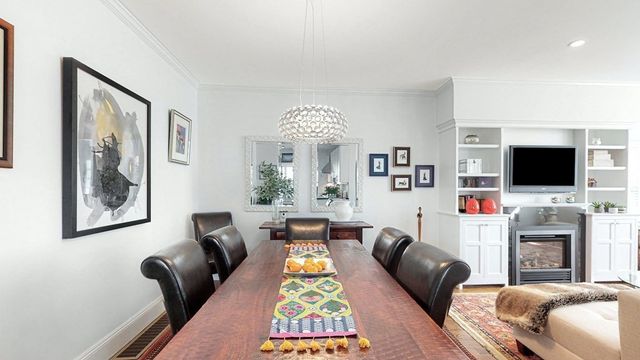 a living room with fireplace furniture and a flat screen tv