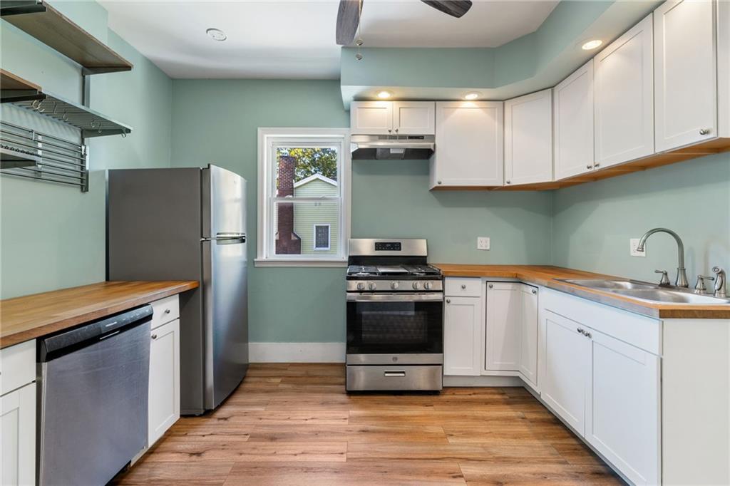 76 Warren Street Pittsburgh, PA 15205 - Photo 12 of 32 a kitchen with stainless steel appliances granite countertop a refrigerator and a sink