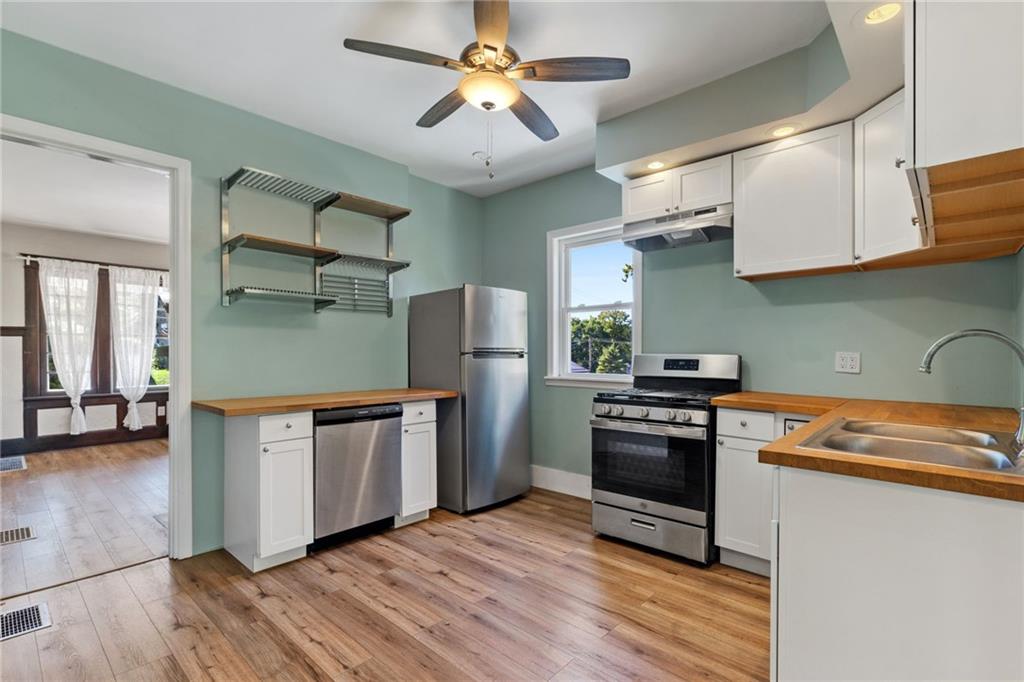 76 Warren Street Pittsburgh, PA 15205 - Photo 13 of 32 a kitchen with stainless steel appliances granite countertop a stove a sink and a refrigerator
