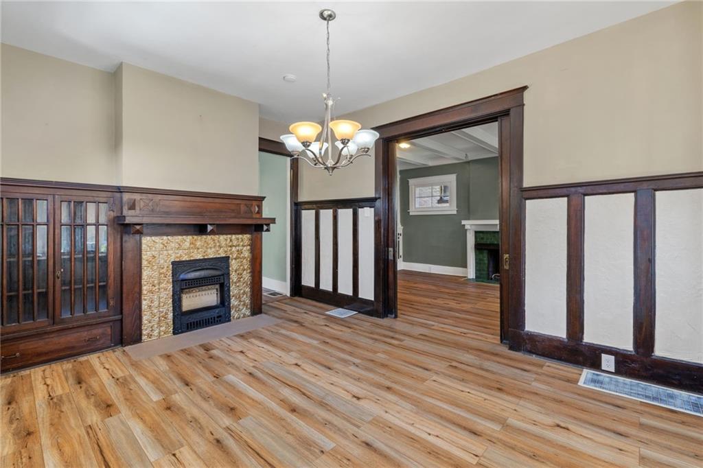 76 Warren Street Pittsburgh, PA 15205 - Photo 9 of 32 a view of a livingroom with a fireplace chandelier and wooden floor