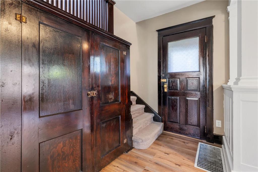 76 Warren Street Pittsburgh, PA 15205 - Photo 10 of 32 a view of a hallway with wooden floor and staircase