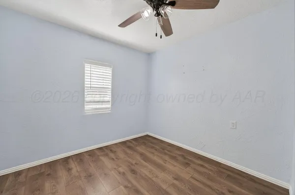 a view of a room with a window and a ceiling fan