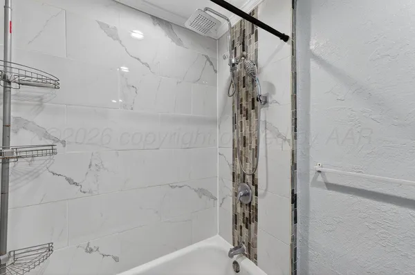 a bathroom with a shower and a tub