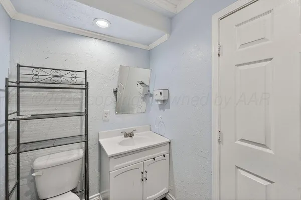 a bathroom with a sink toilet and vanity
