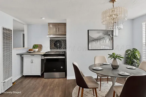 a kitchen with a table and chairs
