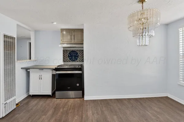 a kitchen with granite countertop a stove and a refrigerator