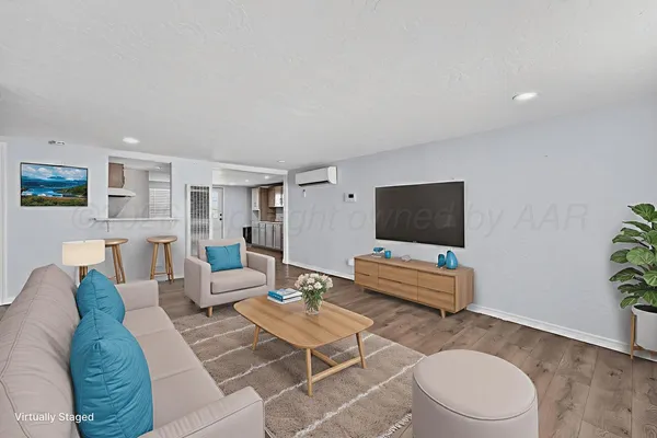 a living room with furniture and a flat screen tv