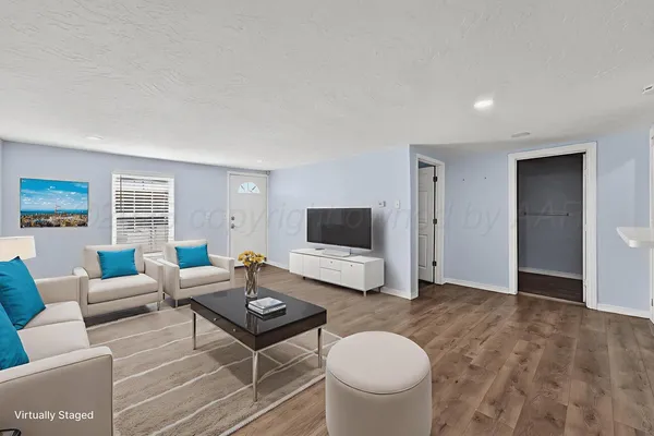 a living room with furniture and a flat screen tv