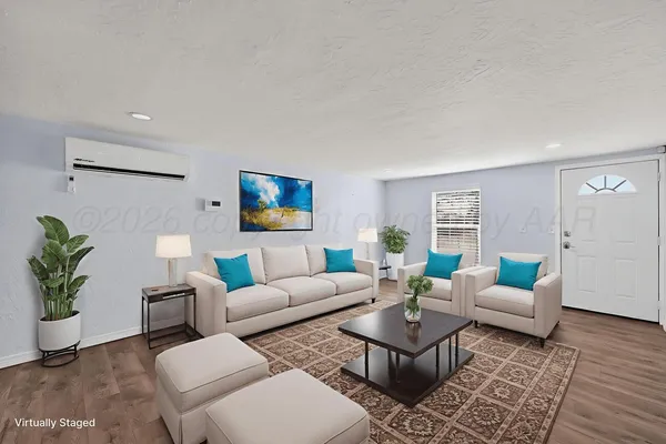 a living room with furniture and wooden floor