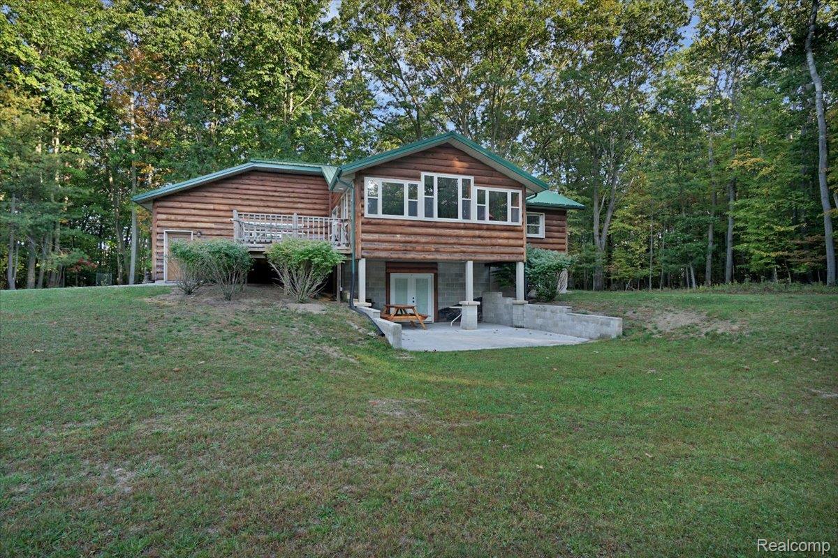 Rear view of house with a patio area and a yard