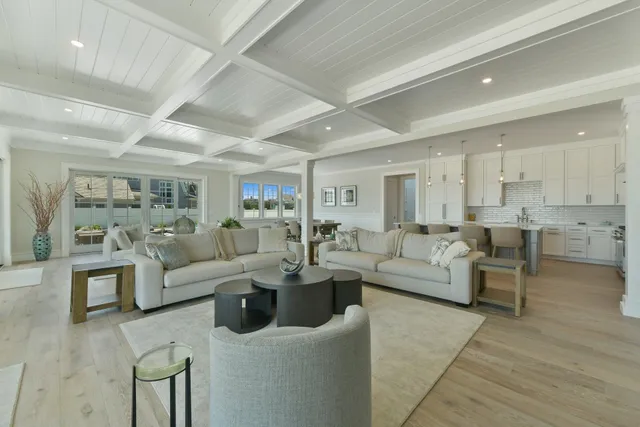 a living room with lots of furniture and view of kitchen