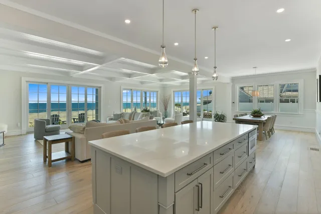 a large kitchen with kitchen island a island a sink a stove and wooden floor