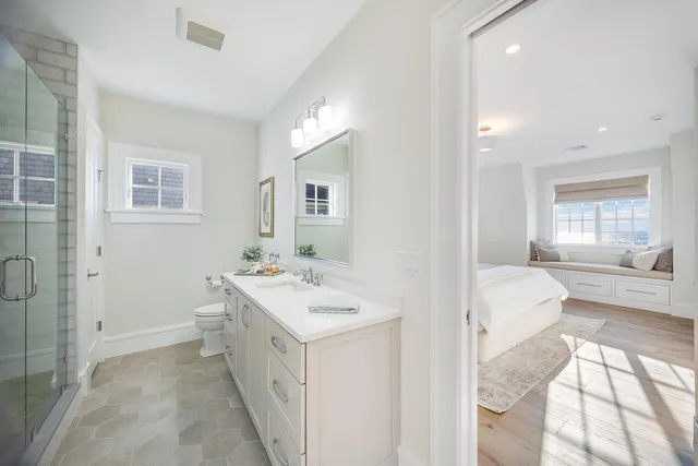 a spacious bathroom with a double vanity sink large mirror and a bathtub