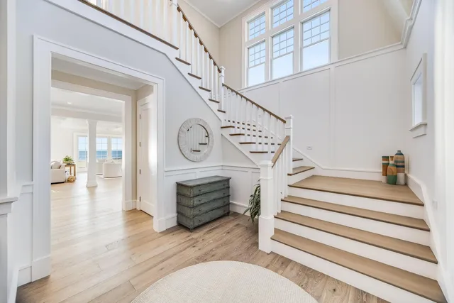a view of entryway livingroom and hall with wooden floor
