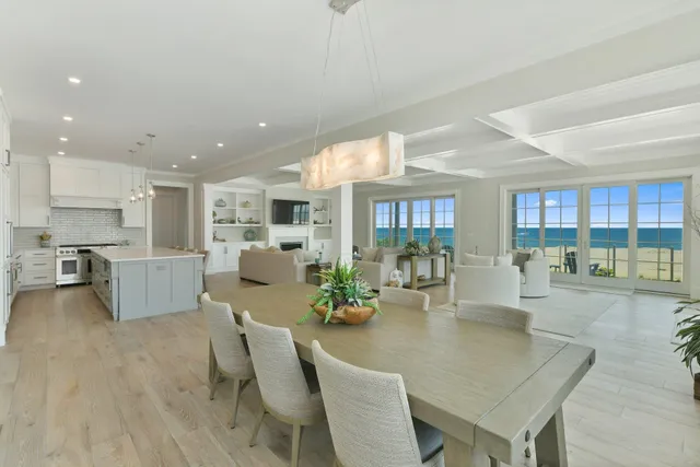 a kitchen with a table chairs refrigerator and cabinets