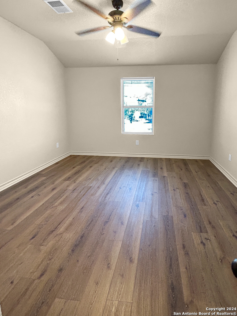 14006 Fratelli Road, Unit 103 San Antonio, TX 78233 - Photo 15 of 16 wooden floor in an empty room with a window