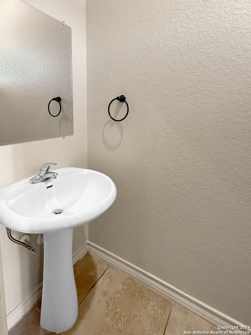 14006 Fratelli Road, Unit 103 San Antonio, TX 78233 - Photo 3 of 16 a bathroom with a sink and mirror