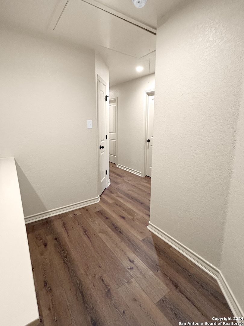14006 Fratelli Road, Unit 103 San Antonio, TX 78233 - Photo 5 of 16 a view of an empty room with wooden floor