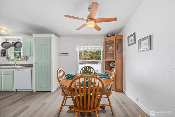a view of a dining room with furniture window and wooden floor