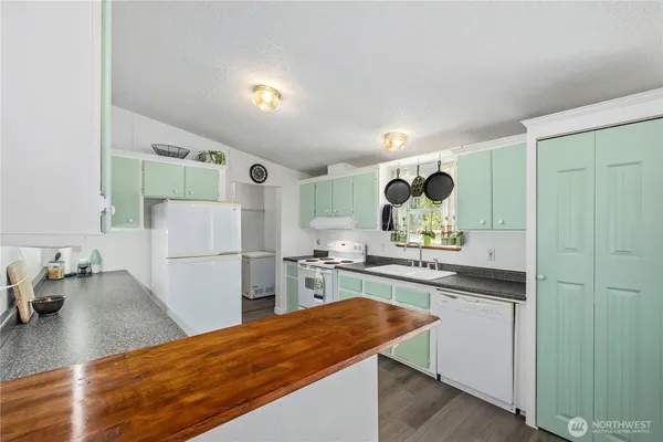 a kitchen with a sink appliances and cabinets
