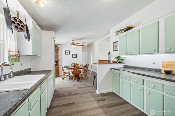 a kitchen with stainless steel appliances granite countertop a sink and cabinets