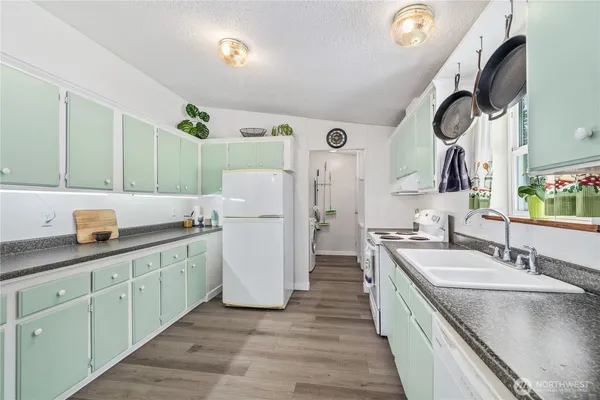 a kitchen with a sink and a refrigerator