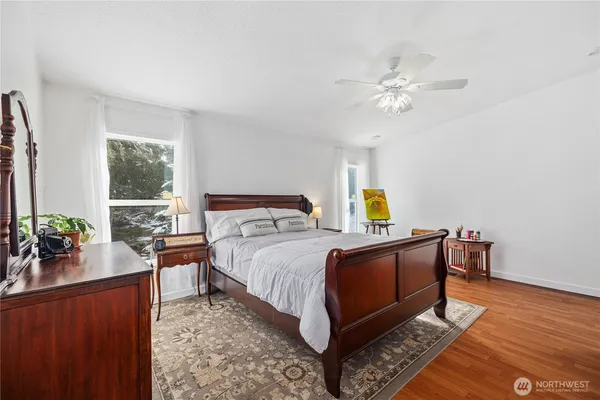 a bedroom with a bed and wooden floor