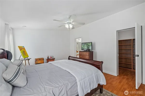 a bedroom with a bed and a chandelier