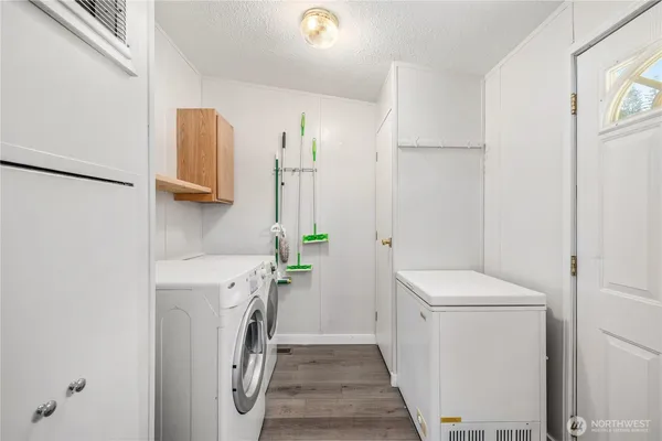 a view of a storage and utility room with washer and dryer