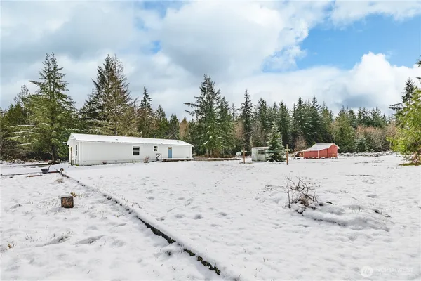 a white house with a snow on the beach
