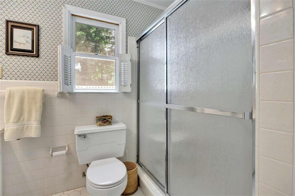 103 Gabriel Way Social Circle, GA 30025 - Photo 43 of 70 a white toilet sitting next to a bathroom sink