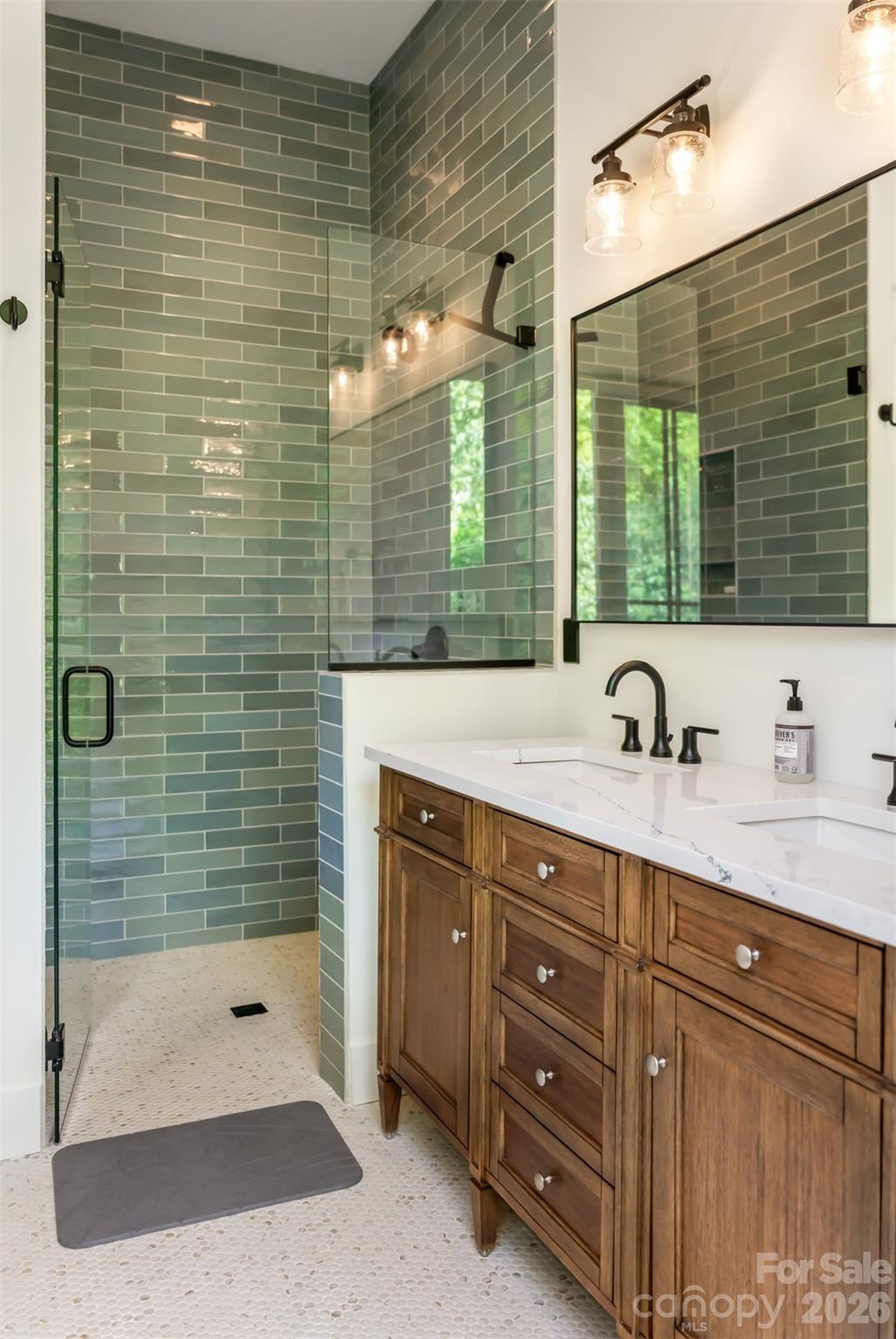 25 Rantis Lane Black Mountain, NC 28711 - Photo 24 of 48 a bathroom with a shower sink and mirror