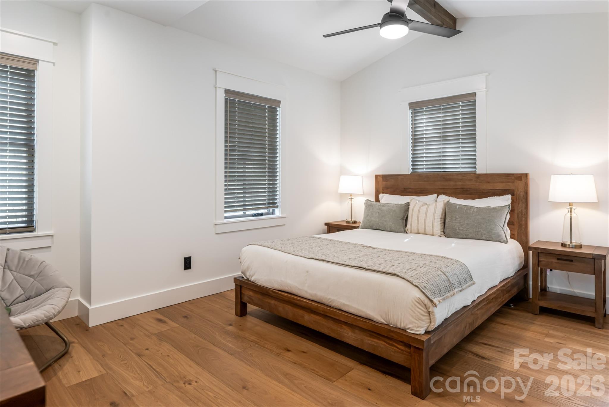 25 Rantis Lane Black Mountain, NC 28711 - Photo 30 of 48 a large bed sitting in a bedroom next to a window and a lamp