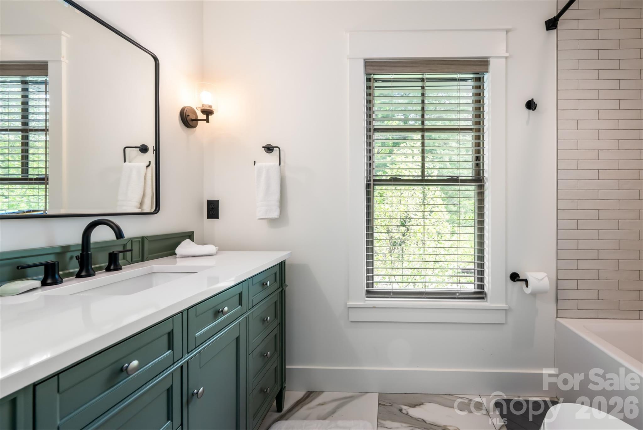 25 Rantis Lane Black Mountain, NC 28711 - Photo 32 of 48 a bathroom with a granite countertop sink and a window