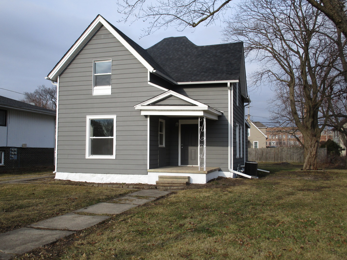 403 West Washington Street Harvard, IL 60033 - Photo 1 of 13 a front view of a house with a garden