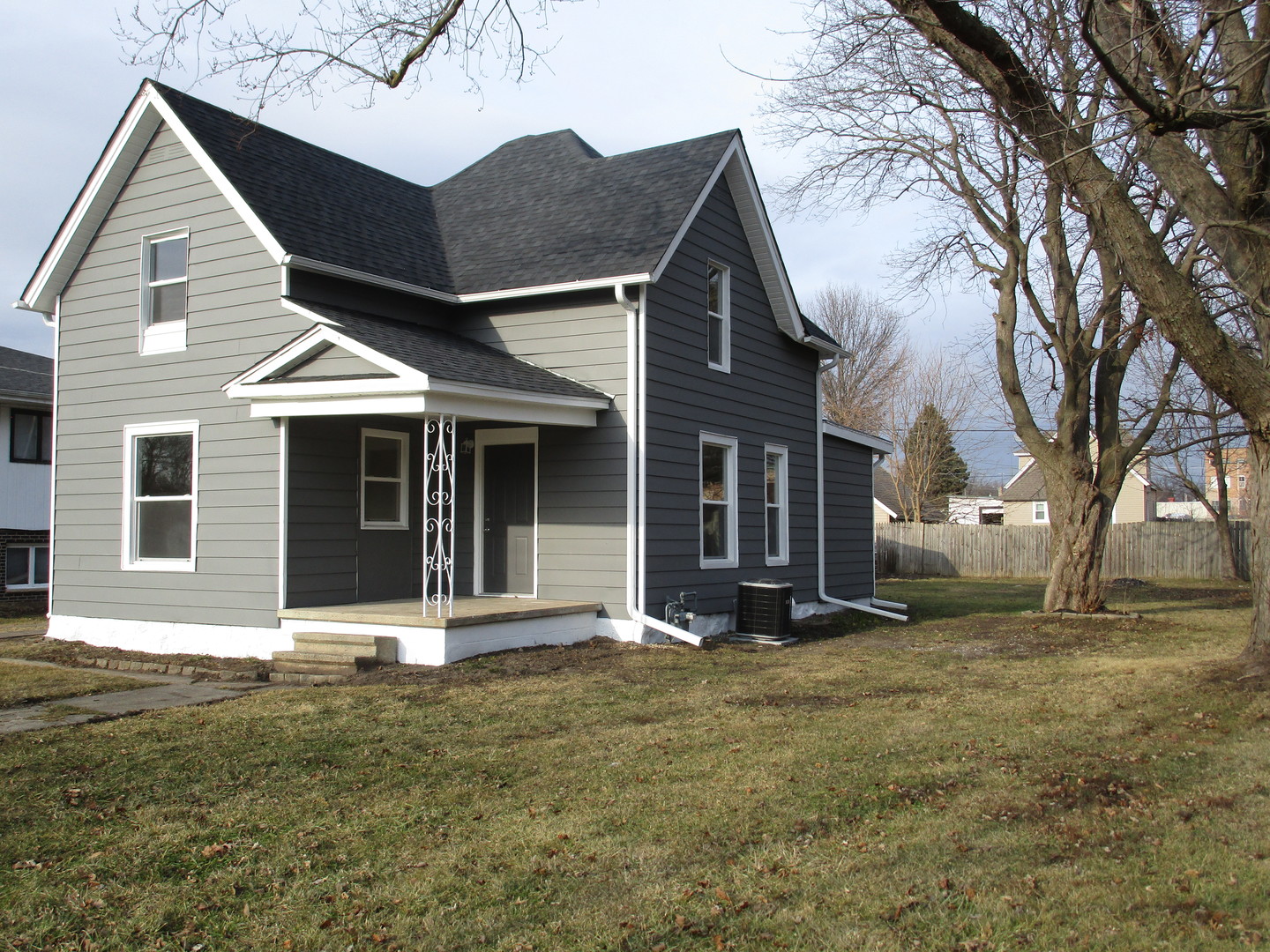 403 West Washington Street Harvard, IL 60033 - Photo 2 of 13 a front view of a house with a garden