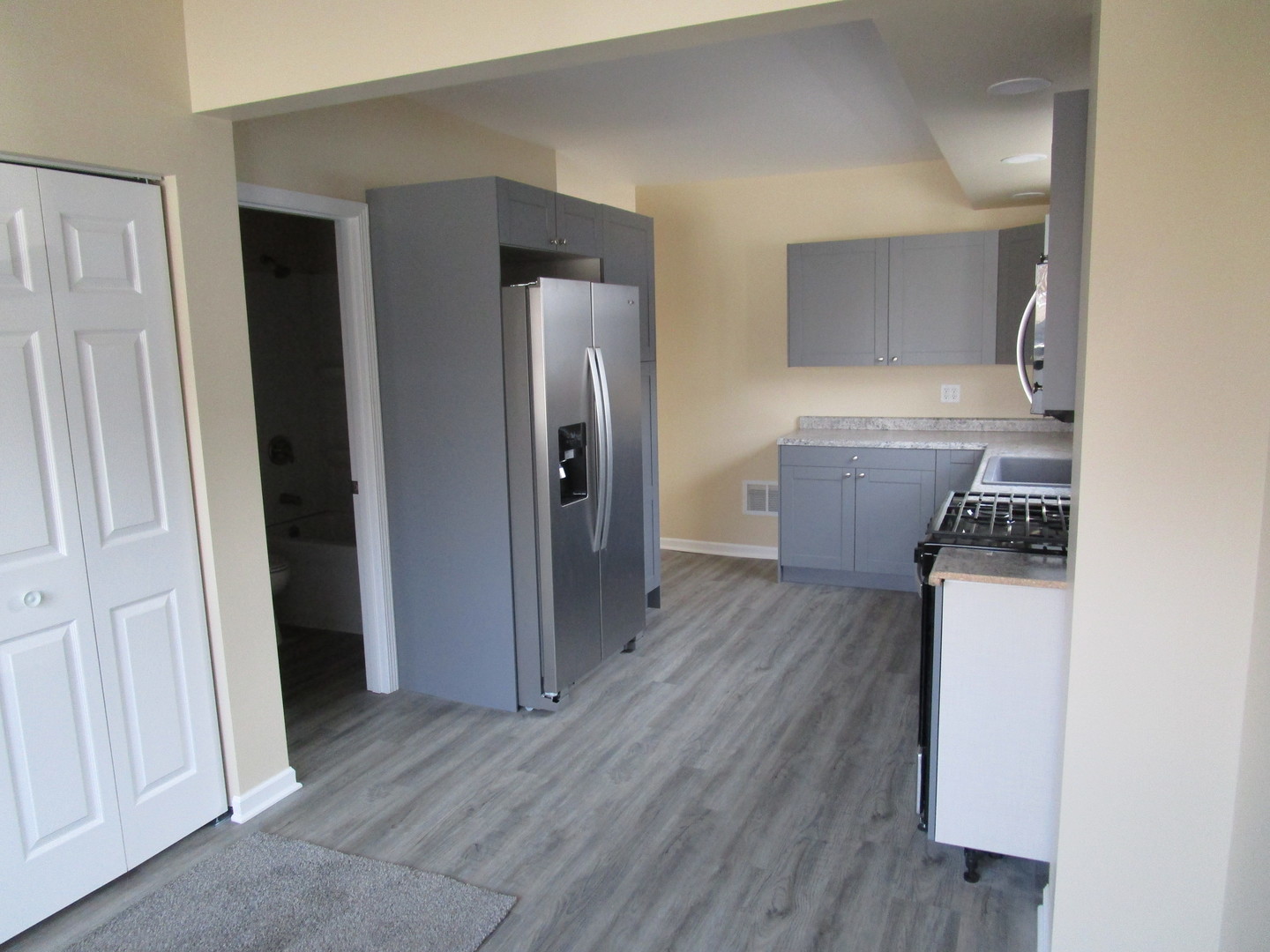 403 West Washington Street Harvard, IL 60033 - Photo 5 of 13 a room with wooden floor and a bathroom