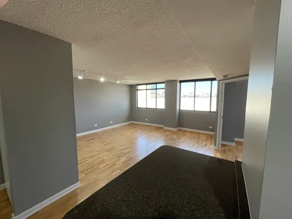a view of wooden floor and windows in a room