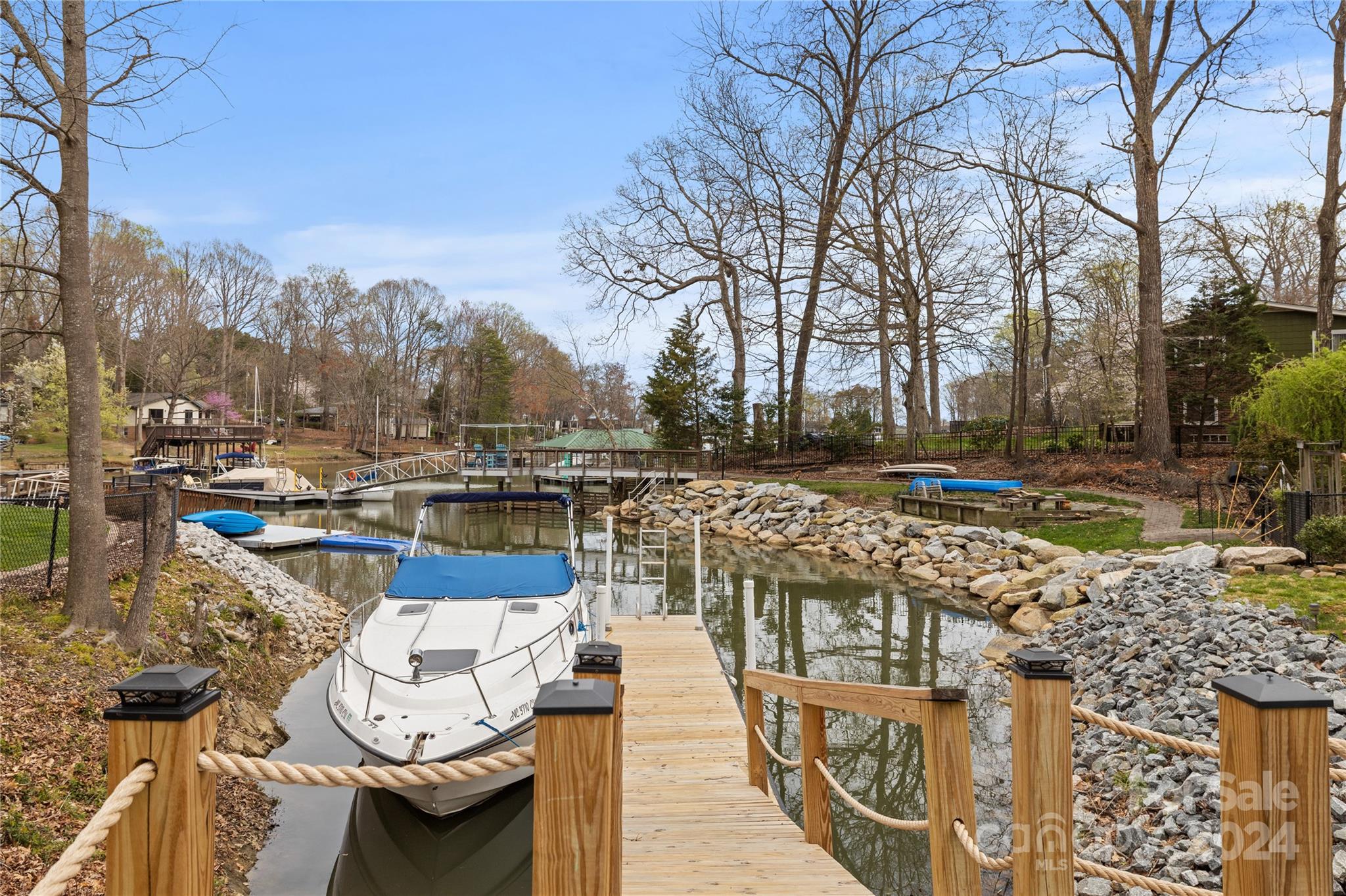 Lot 67 Lake Shore Road South Denver, NC 28037 - Photo 4 of 48 a view of a lake with couches and wooden fence