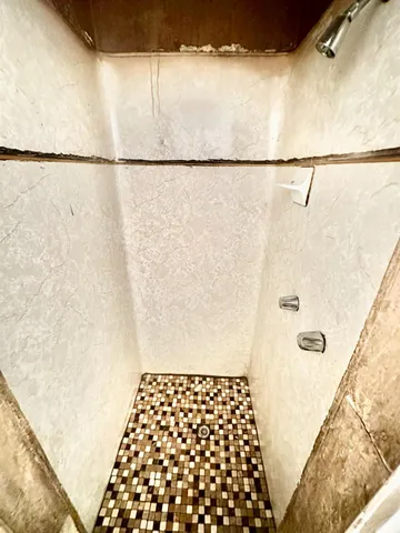 a bathroom with a shower curtain and a sink