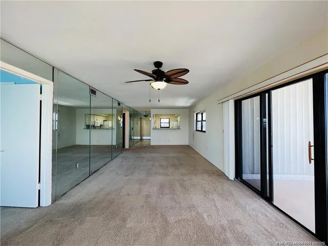 a view of a livingroom with a ceiling fan and window