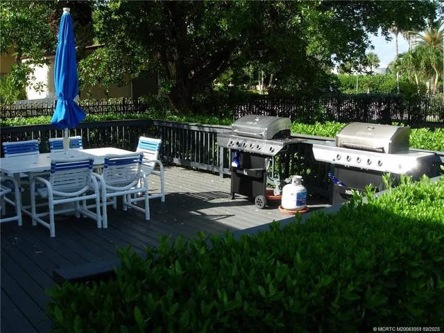 a view of a patio with table and chairs and potted plants